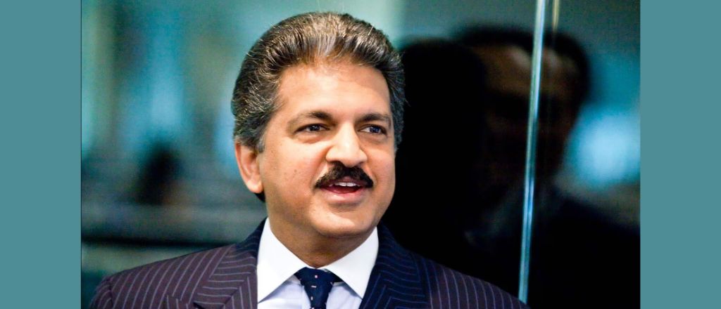 Anand Mahindra, a distinguished figure in a business suit, exudes confidence and leadership.