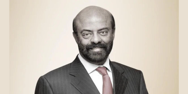Shiv Nadar, founder of HCL Technologies, delivering a speech at an industry conference, exemplifying his visionary leadership and commitment to innovation in the IT sector.