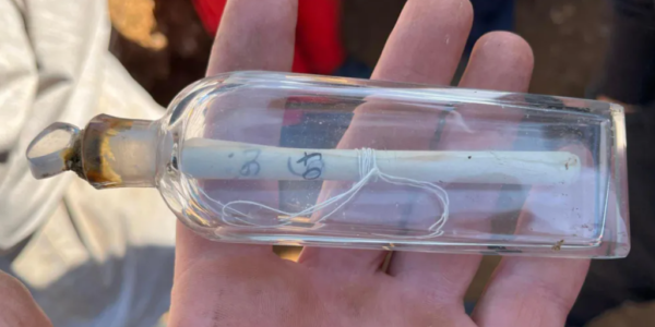 A group of student volunteers excavates an ancient Gaulish village near Dieppe, France, where they discovered a 200-year-old message inside a glass flask. The note, from P.J. Féret, details his past excavations in the area, highlighting the site's historical significance. The team, led by Guillaume Blondel, is investigating the remnants of the settlement amid concerns of erosion.