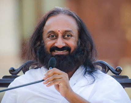 Sri Sri Ravi Shankar smiling during a public event, representing peace and spiritual leadership.