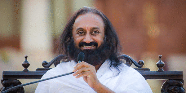 Sri Sri Ravi Shankar smiling during a public event, representing peace and spiritual leadership.