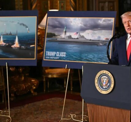 U.S. President Donald Trump walks past a rendering of the Trump-class warship USS Defiant at Mar-a-Lago in Palm Beach, Florida.