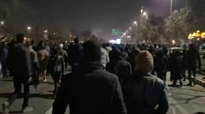 Protesters in Mashhad chant slogans in support of the former monarchy during anti-government demonstrations.