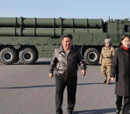 Kim Jong Un walks alongside his daughter Kim Ju Ae during a high-profile military event